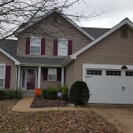 White garage door and house in perfect color harmony with Stockton III lites